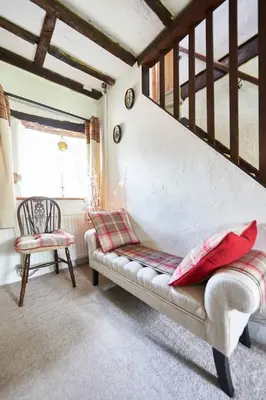 a living room with a couch and a chair at Oronsay, 2 Weint End Cottages, Great Urswick, Ulverston Cumbria LA120SP in Moffat
