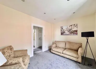 a living room with a couch and a chair at Central Charming Sea View Loft Flat in Troon