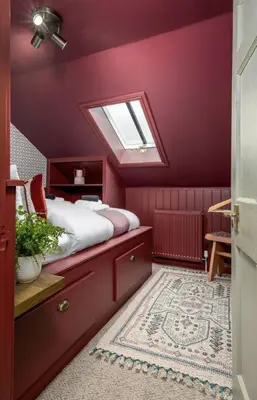 a bedroom with purple walls and a skylight at The Allan Maisonette Charming Georgian Retreat in Stirling