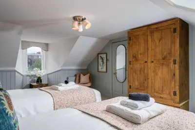a bedroom with two beds with towels on them at The Allan Maisonette Charming Georgian Retreat in Stirling