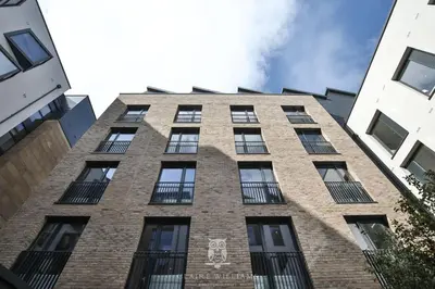 a tall brick building with a skull painted on it at For Students Only - Kings Stables Road in Edinburgh in Edinburgh