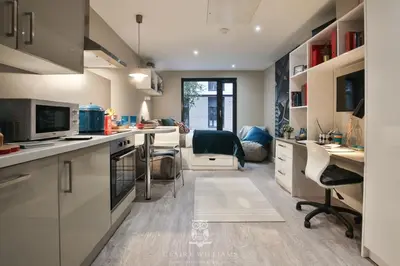 a kitchen with a desk and a living room at For Students Only - Kings Stables Road in Edinburgh in Edinburgh