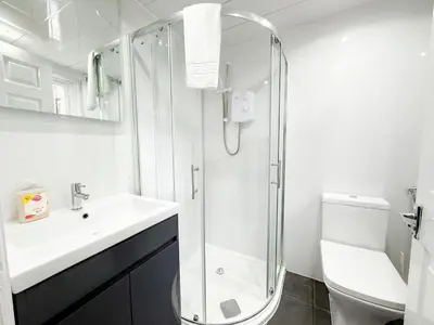 a bathroom with a shower and a sink and a toilet at Glasgow Home Newly Refurbished in Glasgow
