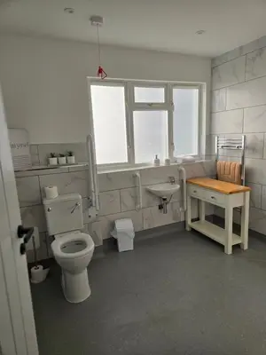 a bathroom with a toilet and a sink at The Post Office Tarbet in Tarbet