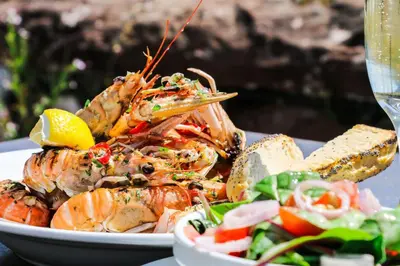 a plate of food with shrimp and a salad at Glenisle Hotel in Isle of Arran