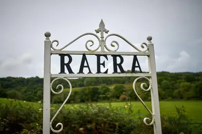 a metal sign that says raritan in a field at Charming 2-Bed Cottage on Tranquil Raera Farm in Kilninver