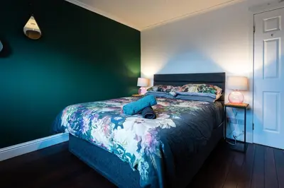 a bedroom with a bed with a dog laying on it at 3 bed, 500mtrs to castle and stunning views in Stirling