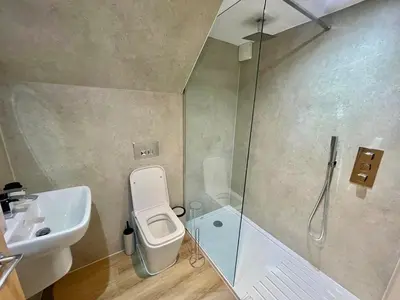 a bathroom with a shower and a toilet and a sink at Three bedroom Apartment In Glasgow City Centre in Glasgow