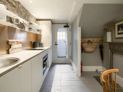 a small kitchen with a sink and a counter at Shipmaster's Townhouse in Queensferry