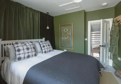 a bedroom with a bed with two pillows on it at Shipmaster's Townhouse in Queensferry