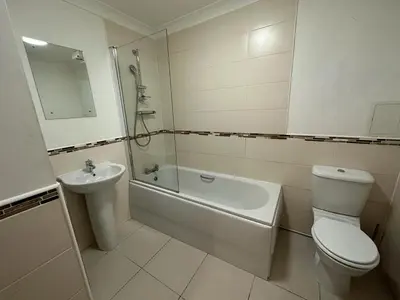 a white bathroom with a toilet and a sink at Cozy Room In Sauchiehall Street in Glasgow