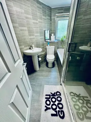 a bathroom with a toilet and a sink and a shower at 3 bedroom apartment in Cumbernauld