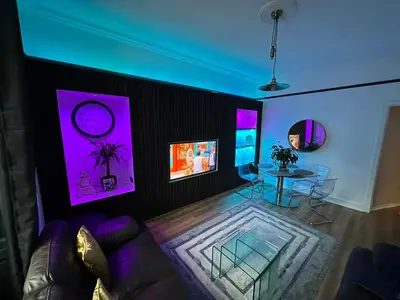 a living room with a couch and a table at 3 bedroom traditional apartment in Ayr