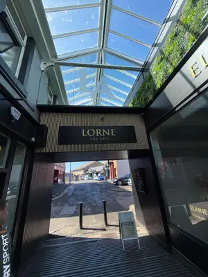 an entrance to a store with a sign on it at 3 bedroom traditional apartment in Ayr