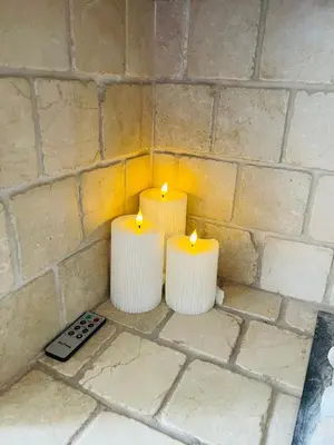 three candles on a wall with a remote control at Lovely 2 bedroom apartment in Ayr town centre in Ayr