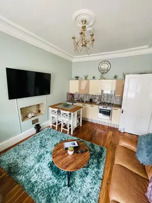 a living room with a table and a couch at Lovely 2 bedroom apartment in Ayr town centre in Ayr