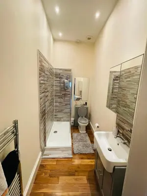 a bathroom with a shower and a toilet and a sink at Lovely 2 bedroom apartment in Ayr town centre in Ayr
