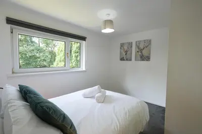 a bedroom with a white bed and a window at Modern 2 Bedroom Platinum Pad Glasgow City in Glasgow