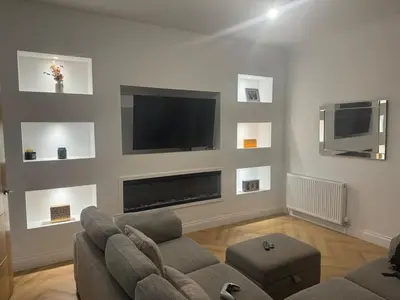 a living room with a couch and a flat screen tv at Stylish modern flat in the centre of Dunfermline in Dunfermline