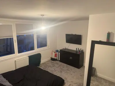 a bedroom with a bed and a flat screen tv at Stylish modern flat in the centre of Dunfermline in Dunfermline