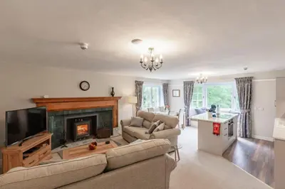 a living room with a couch and a fireplace at Lonan Country House and Gardens in Taynuilt