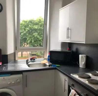 a kitchen with a sink and a window at Cosy, large double room in a shared flat in Edinburgh