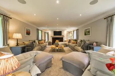a large living room with couches and a fireplace at Finest Retreats - Grassyards House in Largs