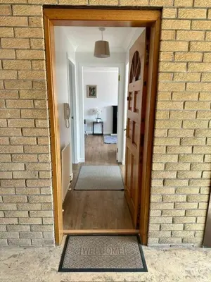 an open door to a room with a hallway at Loch Lomond Apartment in Balloch