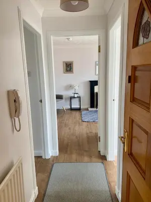 an empty hallway with a door and a room at Loch Lomond Apartment in Balloch