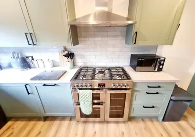 a small kitchen with a stove top oven at Urban 4BR house - Central-FREE parking-NO PARTY in Glasgow