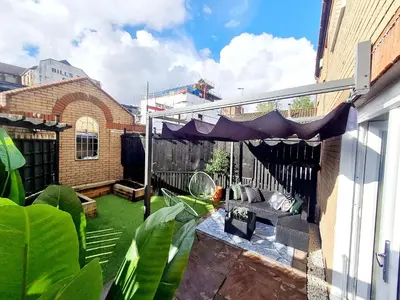 a patio with a couch and a canopy on a balcony at Urban 4BR house - Central-FREE parking-NO PARTY in Glasgow