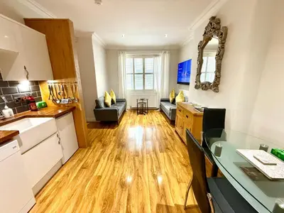 a kitchen and a living room with a kitchen and a living room at Historic Mews House 2BR in Edinburgh City Centre in Edinburgh