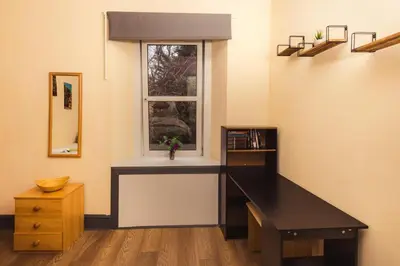 a room with a desk and a window at Cosy Central Apartment by the Meadows 4 in Edinburgh