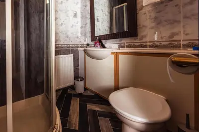 a small bathroom with a toilet and a sink at Cosy Central Apartment by the Meadows 4 in Edinburgh