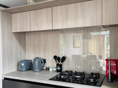 a kitchen with a stove and a counter top at Lime Tree Lodge in Crieff