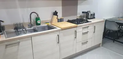 a kitchen with a sink and a stove at Oatlands Oasis-FREE PARKING-2 Minutes from M74 in Glasgow
