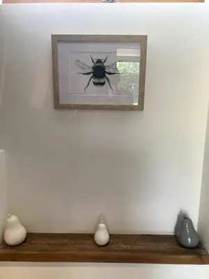 a picture of a bee hanging on a wall at The Cart Barn in Moffat