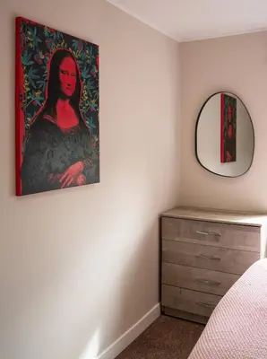 a bedroom with a mirror and a dresser at California House in Falkirk