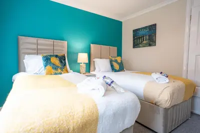 two beds sitting next to each other in a bedroom at Whitburn house in Whitburn