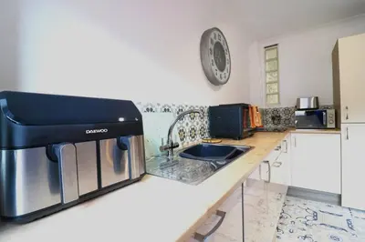 a kitchen counter with a sink and a microwave at Cosy 1 bed flat in central Ayr in Ayr