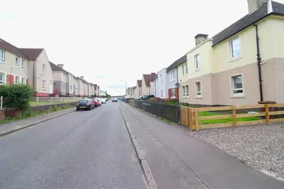a street with houses and cars parked on the road at Lovely 2 BR flat, sleeps 4 in Chapelhall