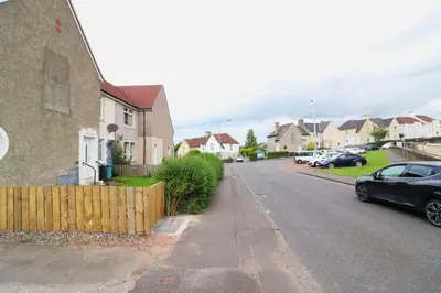 a black car parked on the side of a street at Lovely 2 BR flat, sleeps 4 in Chapelhall