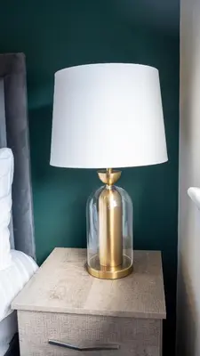 a lamp on a table next to a bed at 2 BDR House At Caledonia Luxe Stays Short Lets & Serviced Accommodation Hamilton in Hamilton