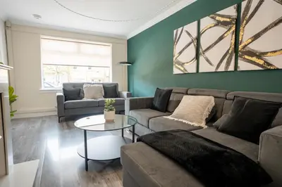 a living room with a couch and a table at 2 BDR House At Caledonia Luxe Stays Short Lets & Serviced Accommodation Hamilton in Hamilton