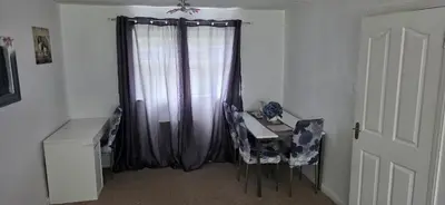 a room with a desk and a table and a curtain at 3 bedrooms home away from home in Uphall