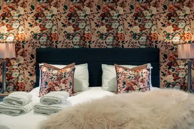 a bedroom with a bed with pillows and a blanket at The Cottage at Barraston Farm in Glasgow