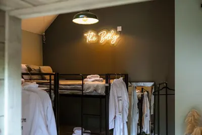 a room with bunk beds and a sign on the wall at Barraston Farm in Glasgow