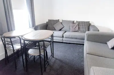 a living room with two stools and a couch at Beech Cottage in Armadale