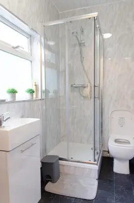 a bathroom with a shower and a toilet and a sink at Beech Cottage in Armadale