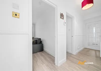 a living room with a couch and a mirror at 2 Bed Sleeps 4 with Private Parking in Airdrie in Airdrie